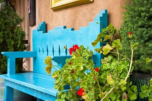 Garden bench next to elegant Santa Fe home